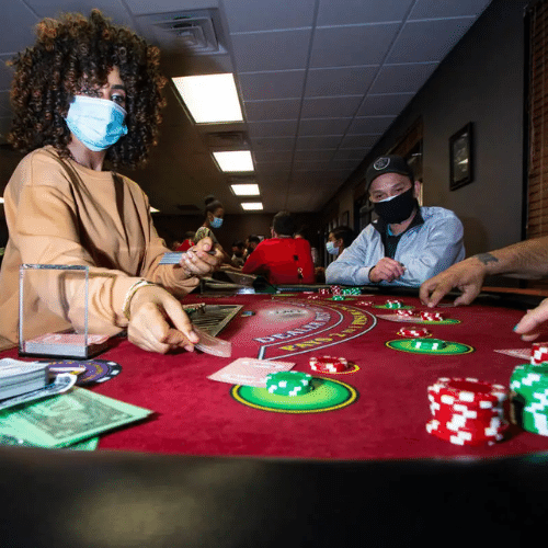 A woman is teaching blackjack to her students at a Las Vegas Dealer School
