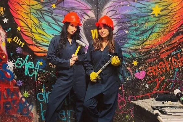 This is a photo of two women who are about to enter the Smash Room in downtown Las Vegas